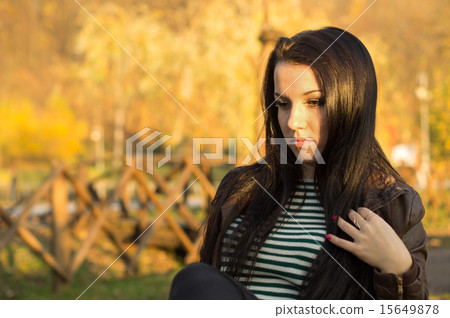 beautiful and sexy girl sitting on bench outdoors 15649878