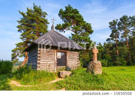 Ancient wooden Orthodox chapel and a stone cross Ancient wooden Orthodox chapel and a stone cross 15650508