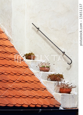Fragment of a red roof on white wall background Fragment of a red roof on white wall background 15651137