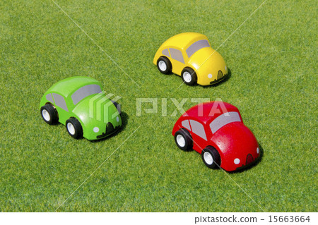 Three wooden car toys on the lawn 15663664