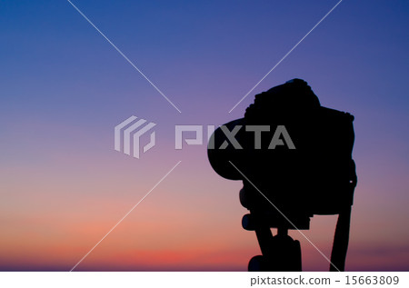 Silhouette of DSLR camera at sea with sunset sky Silhouette of DSLR camera at sea with sunset sky 15663809