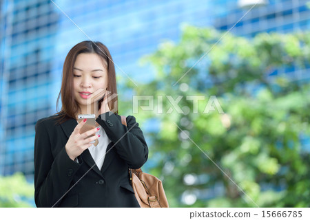 Chinese businesswoman using mobile apps 15666785