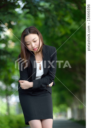 Chinese businesswoman having stomachache 15666896