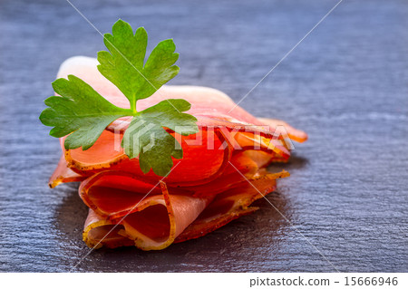 Curled Slices of Delicious Prosciutto with parsley Curled Slices of Delicious Prosciutto with parsley 15666946