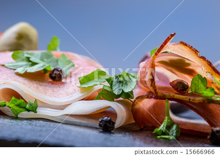 Curled Slices of Delicious Prosciutto with parsley Curled Slices of Delicious Prosciutto with parsley 15666966