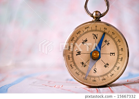Compass Instrument Standing on Top of Map Compass Instrument Standing on Top of Map 15667332