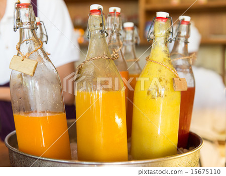 bottles of juice in ice bucket at market 15675110