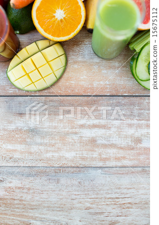close up of fresh juice glass and fruits on table 15675112