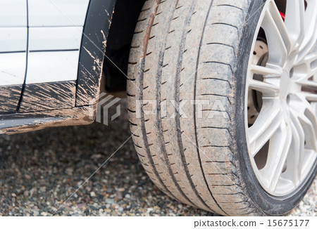 close up of dirty car wheel on ground 15675177