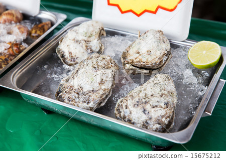 oysters or seafood on ice at asian street market oysters or seafood on ice at asian street market 15675212