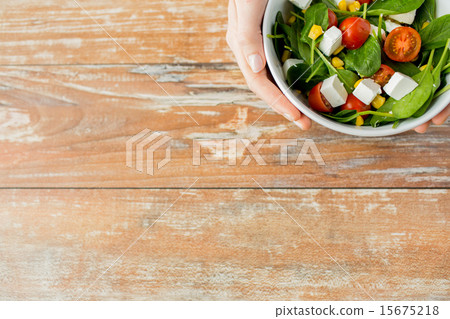 close up of young woman hands with salad bowl close up of young woman hands with salad bowl 15675218
