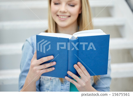 close up of young woman reading book at school 15675561