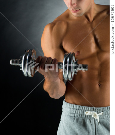 close up of young man with dumbbell close up of young man with dumbbell 15675603