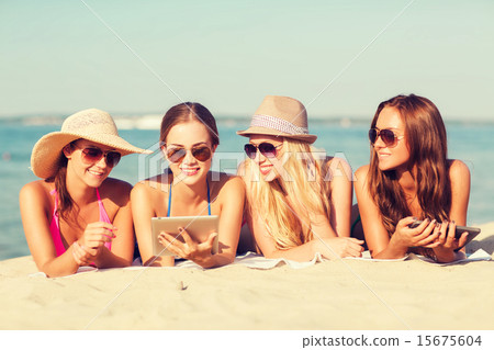 group of smiling young women with tablets on beach group of smiling young women with tablets on beach 15675604
