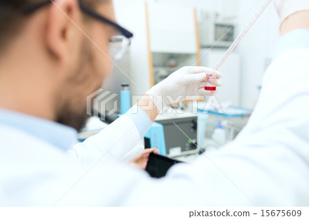 close up of scientist with tube and pipette in lab close up of scientist with tube and pipette in lab 15675609