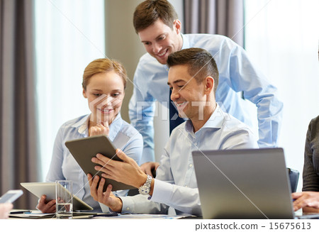 smiling business people with tablet pc in office 15675613