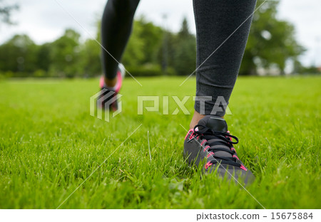 close up of exercising woman legs on grass in park 15675884