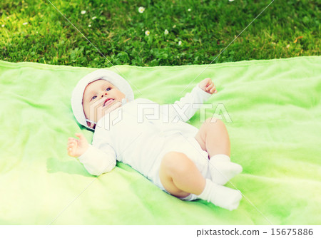smiling baby lying on floor and looking up 15675886