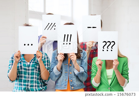 friends or students covering faces with papers 15676073