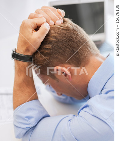 stressed businessman at work stressed businessman at work 15676139