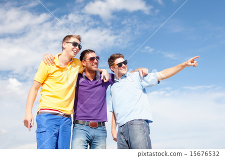 smiling friends in sunglasses pointing finger 15676532