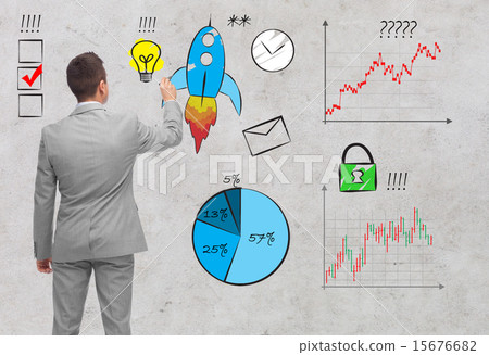 businessman pointing to business symbols from back 15676682