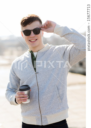 smiling young man or boy drinking coffee 15677713