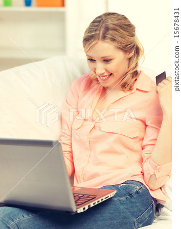 happy woman with laptop computer and credit card 15678431