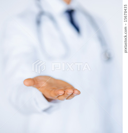 male doctor holding something in his hand male doctor holding something in his hand 15678435