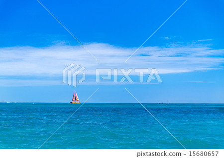 A red boat floating off the coast of Waikiki Beach A red boat floating off the coast of Waikiki Beach 15680657