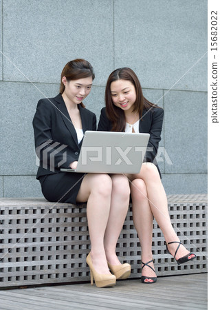 2 Chinese woman using laptop outdoors 2 Chinese woman using laptop outdoors 15682022