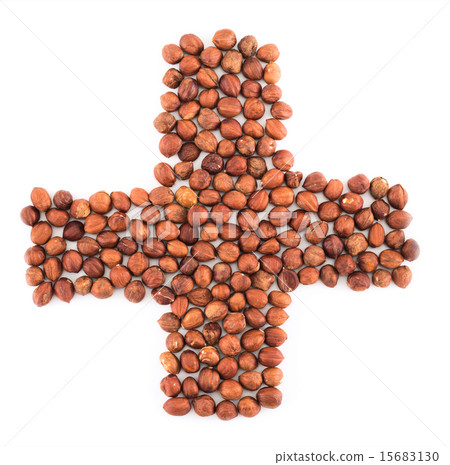 Cross plus shape made of hazelnuts isolated Cross plus shape made of hazelnuts isolated 15683130