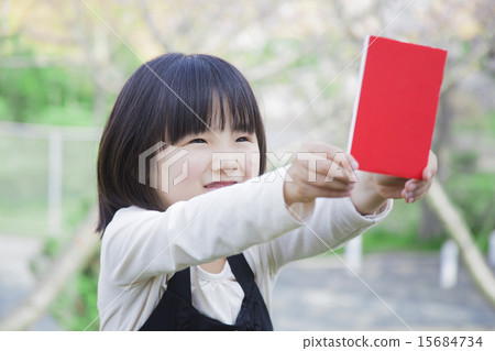 A girl with a red card 15684734