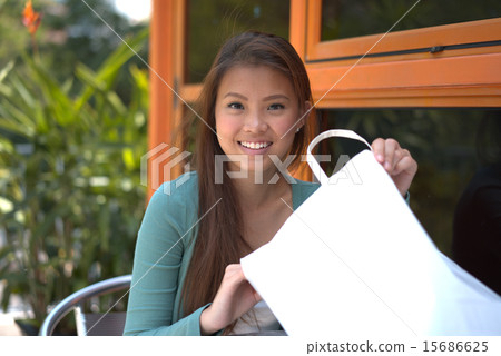 Young asian teenage girl delighted with her shopping 15686625