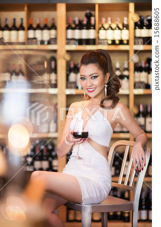 Beautiful asian woman with a glass of wine Beautiful asian woman with a glass of wine 15688605