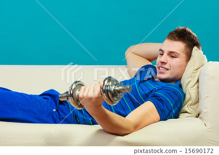Young man fit body relaxing on couch after training 15690172