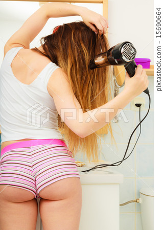 long haired woman drying hair in bathroom rear view 15690664