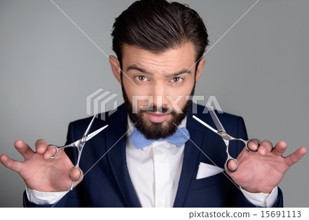 Stylish man with beard holding scissors Stylish man with beard holding scissors 15691113