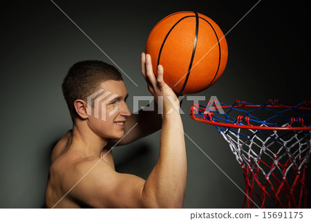 Basketball athlete throwing ball into the basket Basketball athlete throwing ball into the basket 15691175