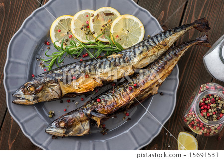 Baked Mackerel Fish with Herbs and Lemon on Plate 15691531