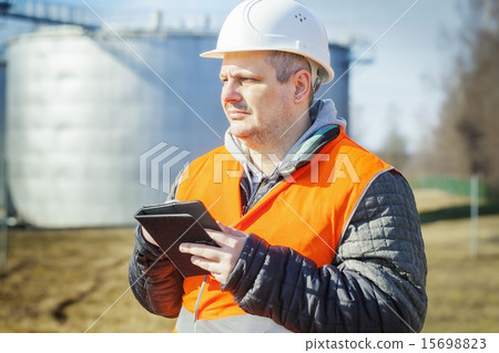 Engineer working with tablet PC in the factory Engineer working with tablet PC in the factory 15698823