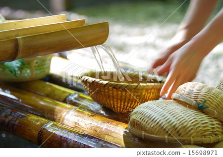 Women's hand setting bamboo salmon on the flow of Shimizu with bamboo toys of sushi noodle soup at Takachiho Gorges in Miyazaki prefecture 15698971