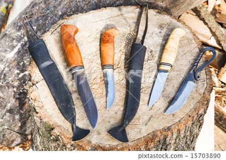 bowie knives on wooden stump 15703890