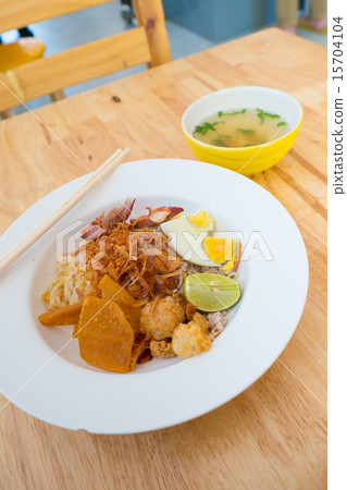 Asian dry noodle with garnish on the wooden background 15704104