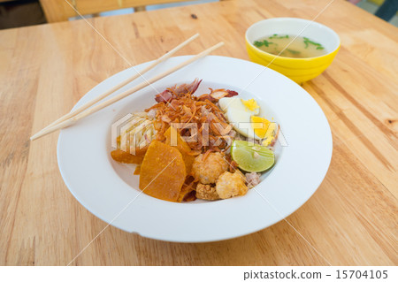 Asian dry noodle with garnish on the wooden background Asian dry noodle with garnish on the wooden background 15704105