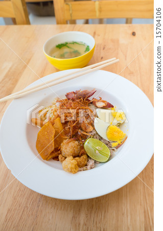 Asian dry noodle with garnish on the wooden background Asian dry noodle with garnish on the wooden background 15704106