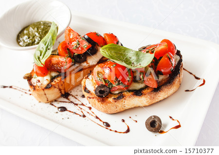 Bruschetta with tomato, mozarella and basil Bruschetta with tomato, mozarella and basil 15710377