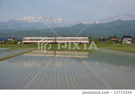Local Steel Train running against the North Alps / Tateyama mountain range Local Steel Train running against the North Alps / Tateyama mountain range 15715034