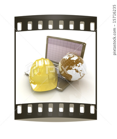 Hard hat and earth on a laptop. The film strip 15716235
