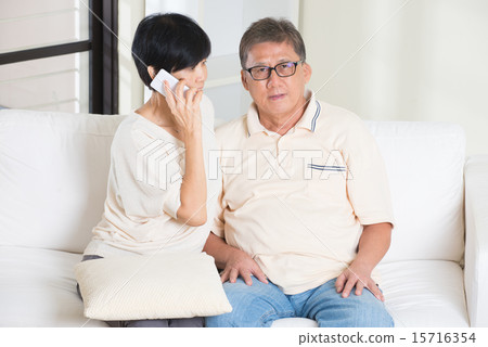 asian senior couple having phone conversation 15716354